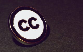 A Pin with the Creative Commons Logo on it