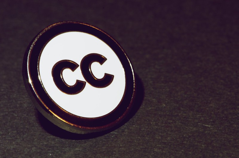 A Pin with the Creative Commons Logo on it